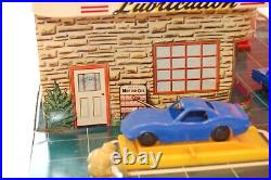 Antique toy automobile service center. Spectacular art work. Approx 1958-1960